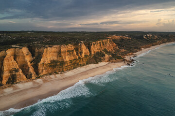 Portugal’s Praia de Vale Furado – wild Atlantic beach with golden cliffs, soft sand and...