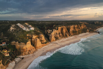 Portugal’s Praia de Vale Furado – wild Atlantic beach with golden cliffs, soft sand and...