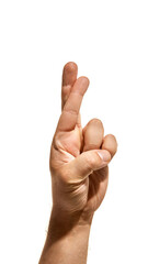Hand with crossed fingers in symbolic hope gesture. Concept of luck, optimism, and meaningful...