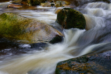 mountain river flowing water moss on stone blurred water