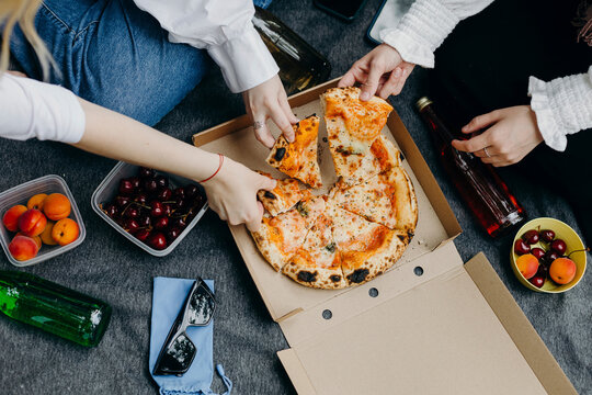 Young friends having pizza together