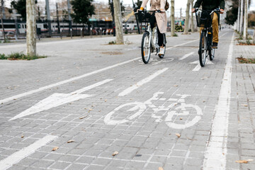Couple riding e-bikes in the city on bicycle lane