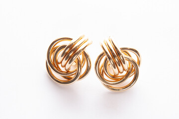 Gold earrings on white background
