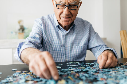 Senior man doing a jigsaw