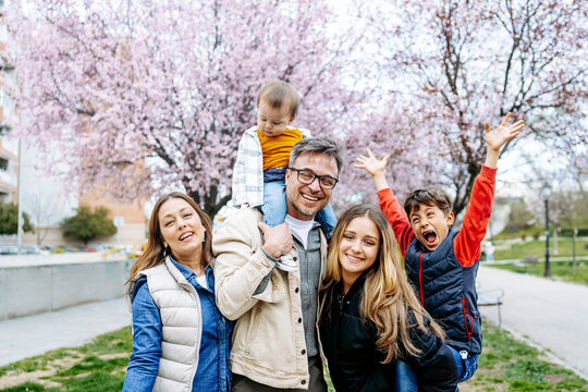Cheerful family spending leisure time at park