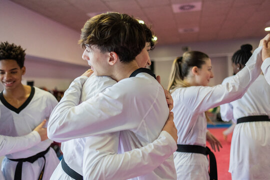 Judo training session with a diverse group embracing in Madrid