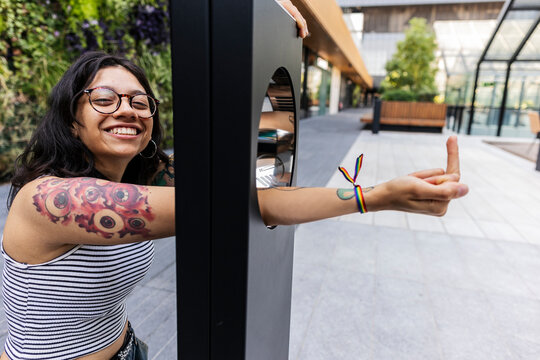 Smiling lesbian woman showing middle finger