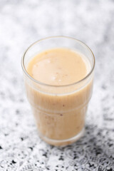 Pineapple coconut smoothie on bright background. Soft focus. Copy space.