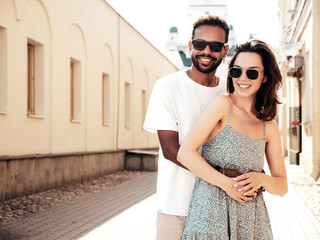 Smiling beautiful woman and her handsome boyfriend. Woman in casual summer clothes. Happy cheerful...