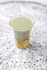 Coconut and pistachio smoothie on bright background. Soft focus. Copy space.	