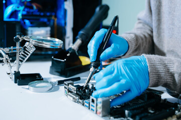 Computer technician in gloves safely repairing desktop hardware. Closeup view of hands fixing GPU...