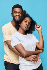 Fototapeta premium Happy couple embracing against a blue background, showcasing love and connection in a vibrant and modern style