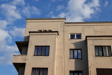 Modernist Apartment Facade under Summer Sky in Cluj-Napoca, Romania