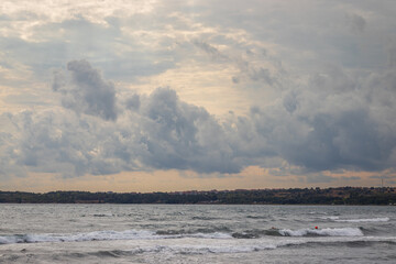 Heavy dark blue clouds on the sky. Sea before rain. 