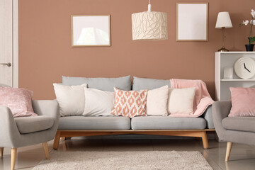 Interior of living room with lamps, sofa and armchairs