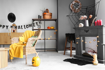 Interior of living room decorated for Halloween with armchair, shelf unit and mantelpiece