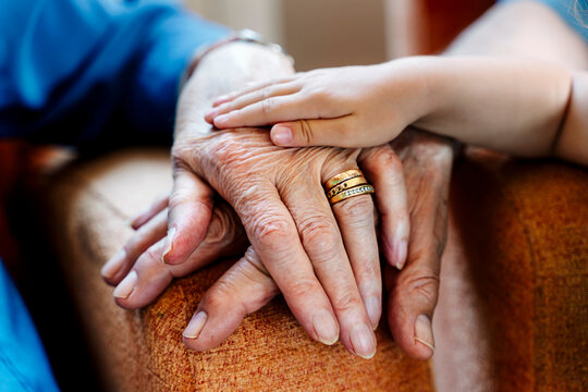 Elderly couple and baby's hand, generations together