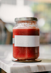 Refreshing watermelon juice in glass jar with blank label for branding mockup