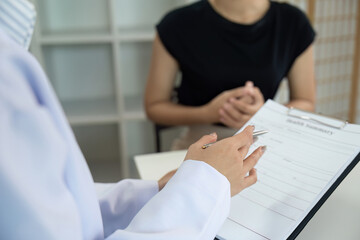 Patient Consultation. Doctor explaining health information to patient in office.