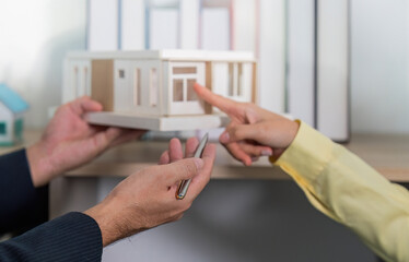 Architectural Discussion. Client examining model home with real estate agent.