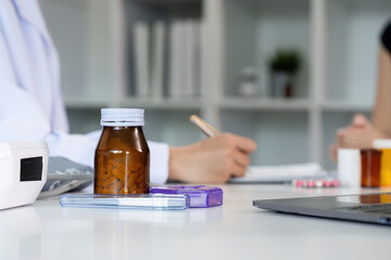 Healthcare Consultation. Doctor discussing medication with patient in modern clinic.