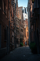 Antwerp, Belgium – August 2025: Editorial image of a narrow alley with traditional brick houses,...