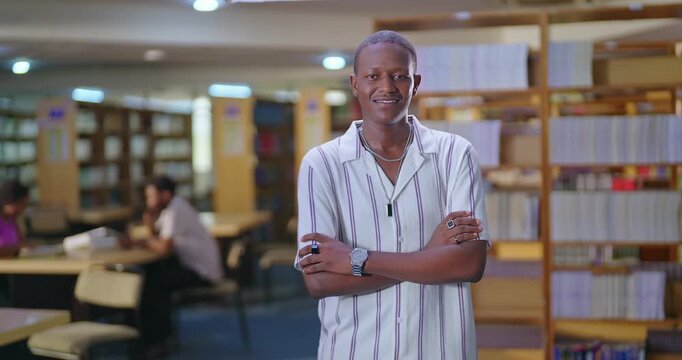 African young adult gen z man happy confident student standing proud fold hand look camera indoor library ready for exam smiling smart boy cross arms staring cam do pose enjoy day time inside college