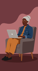 Focused senior Black woman in glasses and denim jacket uses a laptop in a comfortable armchair, highlighting modern digital lifestyle and remote connectivity.