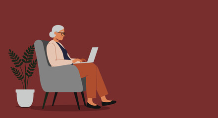 Happy senior woman in glasses relaxing on an armchair, working on a laptop computer. Modern elderly living, remote work, or online learning concept.