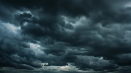 Ominous, textured grey storm clouds filling the frame, hinting at a break in the middle