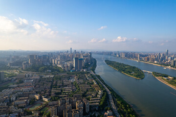High above China, Changsha City presents its sprawling urban landscape, a wide river winding...