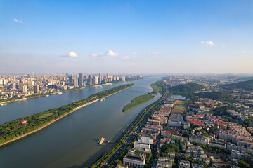 Aerial view captures the sprawling urban landscape of Changsha City, China, with its winding river...