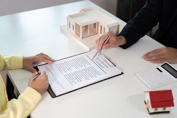 Real Estate Contract Signing. Client reviewing and signing property agreement.