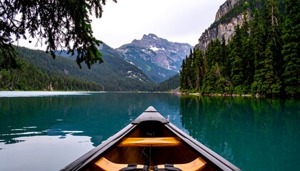 Fototapeta premium A tranquil mountain lake scene, with a canoe in the foreground, showcasing a serene and peaceful atmosphere.