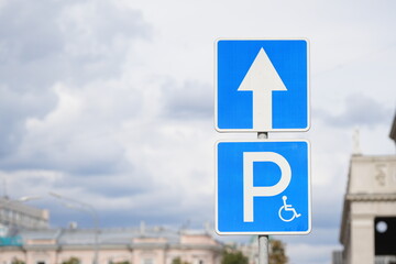 Road sign indicating direction to parking for disabled drivers
