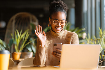 Energetic African-American social media manager handling direct messages, crafting timely and friendly brand responses across multiple platforms.