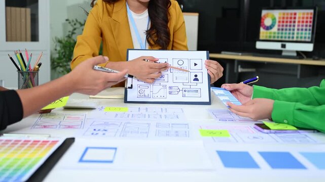 UX graphic designer planning application process development prototype wireframe for web smart phone. Creative digital development agency.
