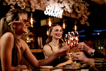 Elegant Friends Enjoying Drinks at a Sushi Restaurant in Warm Evening Light