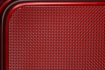 A macro shot shows a detail of the red, textured surface of a baking pan with a rounded edge