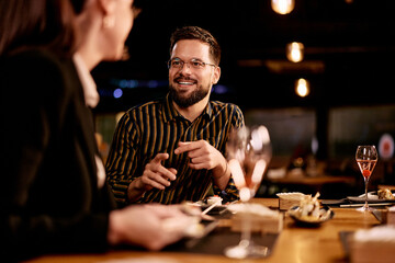 Cheerful Friends Dining and Enjoying Conversation in a Cozy Restaurant Setting