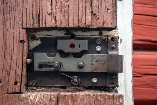Aged lock mechanism detail on wooden door