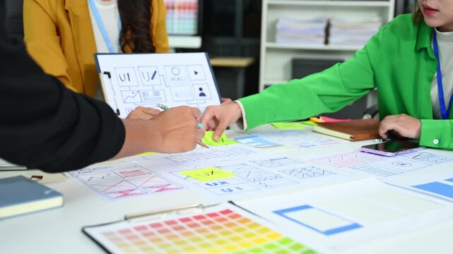 UX graphic designer planning application process development prototype wireframe for web smart phone. Creative digital development agency.