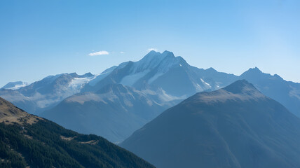 Majestic snow capped mountain peaks under a clear blue sky