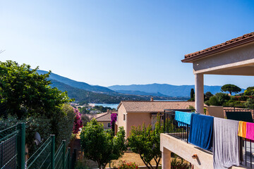 View over residential houses towards mountains and coastline France Corsica 18 June 2025