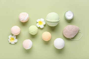 Composition with different bath bombs, cream and sponge on color background