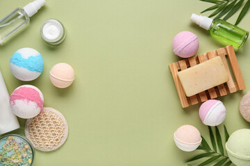 Composition with different bath bombs and cosmetic products on green background