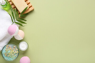 Composition with cosmetic products, bath bombs and towel on color background