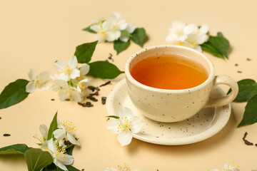Cup of hot jasmine tea with flowers on beige background, closeup