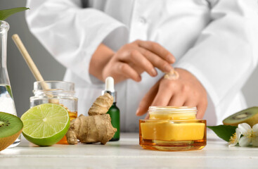 Cosmetologist preparing natural cosmetics at table