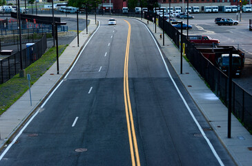 Empty City Road Curving Through Commercial Buildings